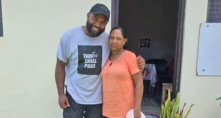 Man smiling with arm around woman