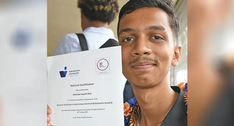 A photo of Nischal Dea holding up his national qualification certificate.
