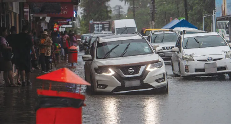 A car attempts to drive through flooded waters in Lami Town after heavy rainfall on January 8, 2025.