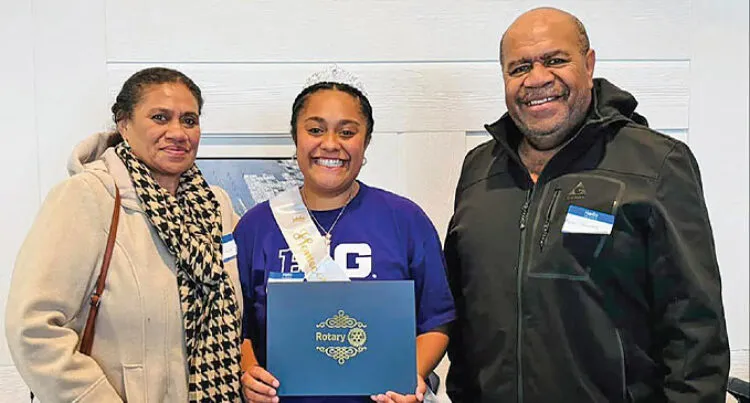 Deborah Selenia Vasuilakeba pictured smiling and standing between her aunt Selenia and uncle Aseri Kunawave.