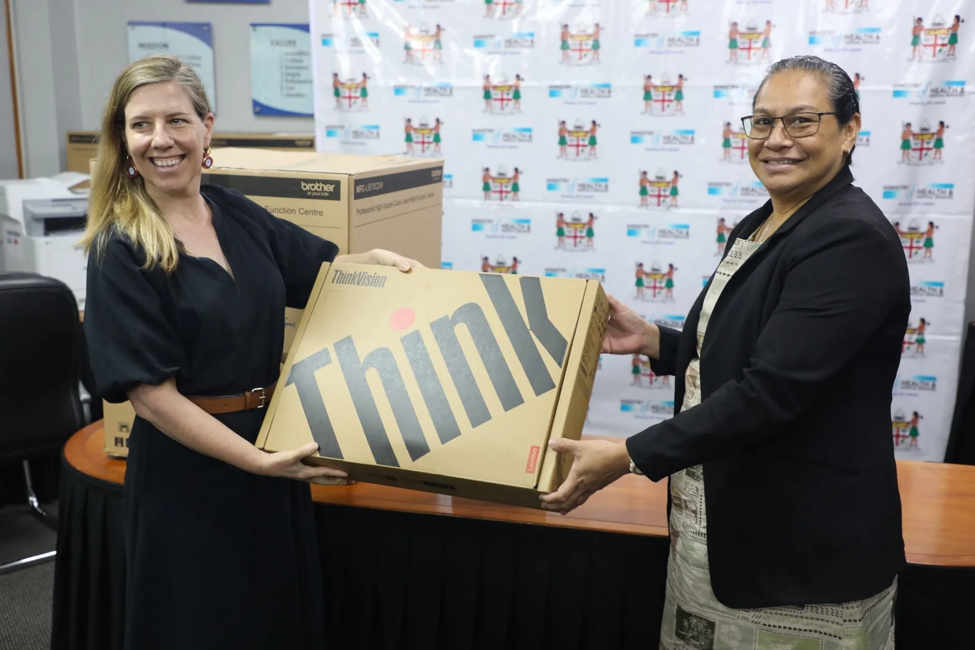 Counsellor Human Development at the Australian High Commission in Fiji, Emaline Cammack (left) handing over equipment to Ministry of Health Chief Medical Advisor, Dr Luisa Cikamatana. 