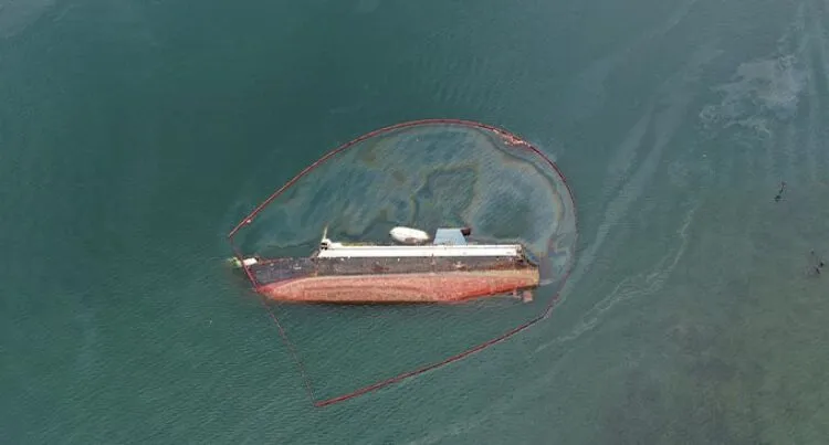 An arial photograph of a major oil spill in Suva Harbour, linked to the abandoned sunken Lomaiviti Princess II.